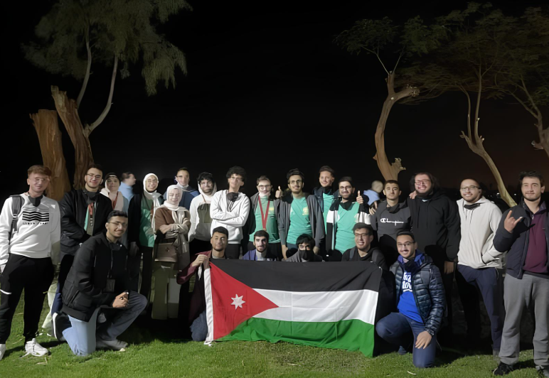 BMT participants celebrating with the Jordanian flag after a challenge event