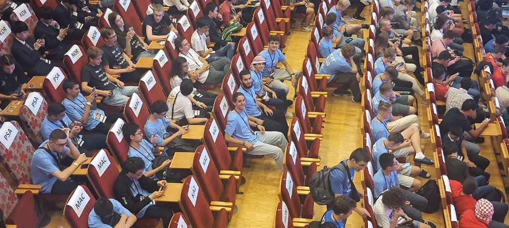Large auditorium hosting a national programming competition in Jordan