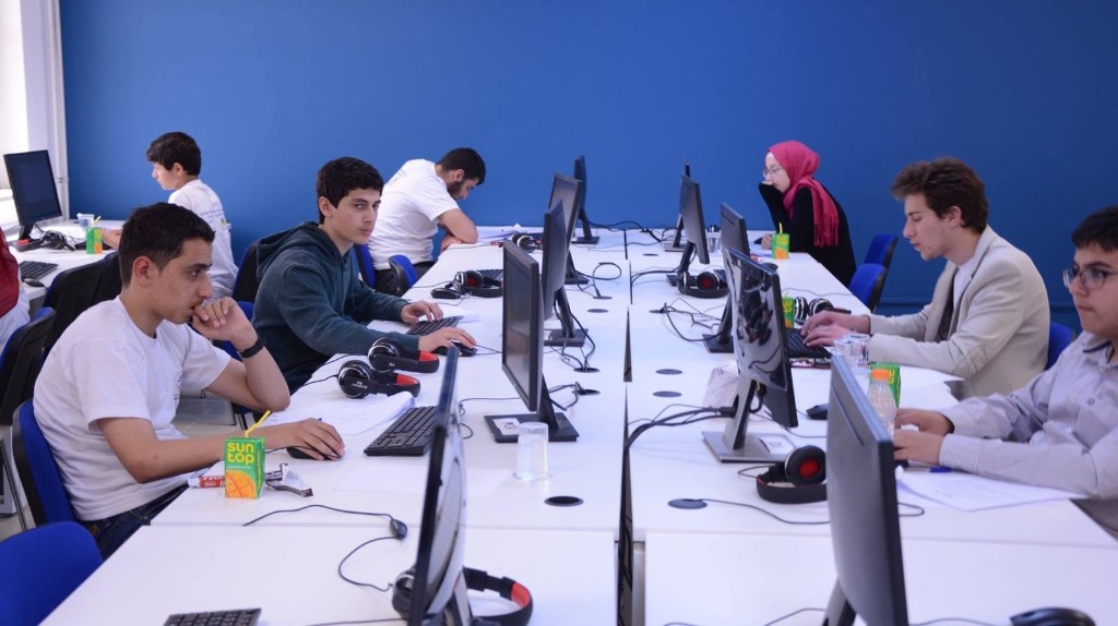 School outreach workshop with students at programming workstations